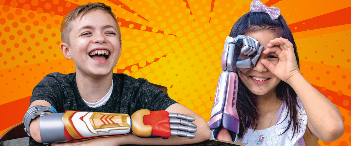 Image of two kids with colorful robotic arms